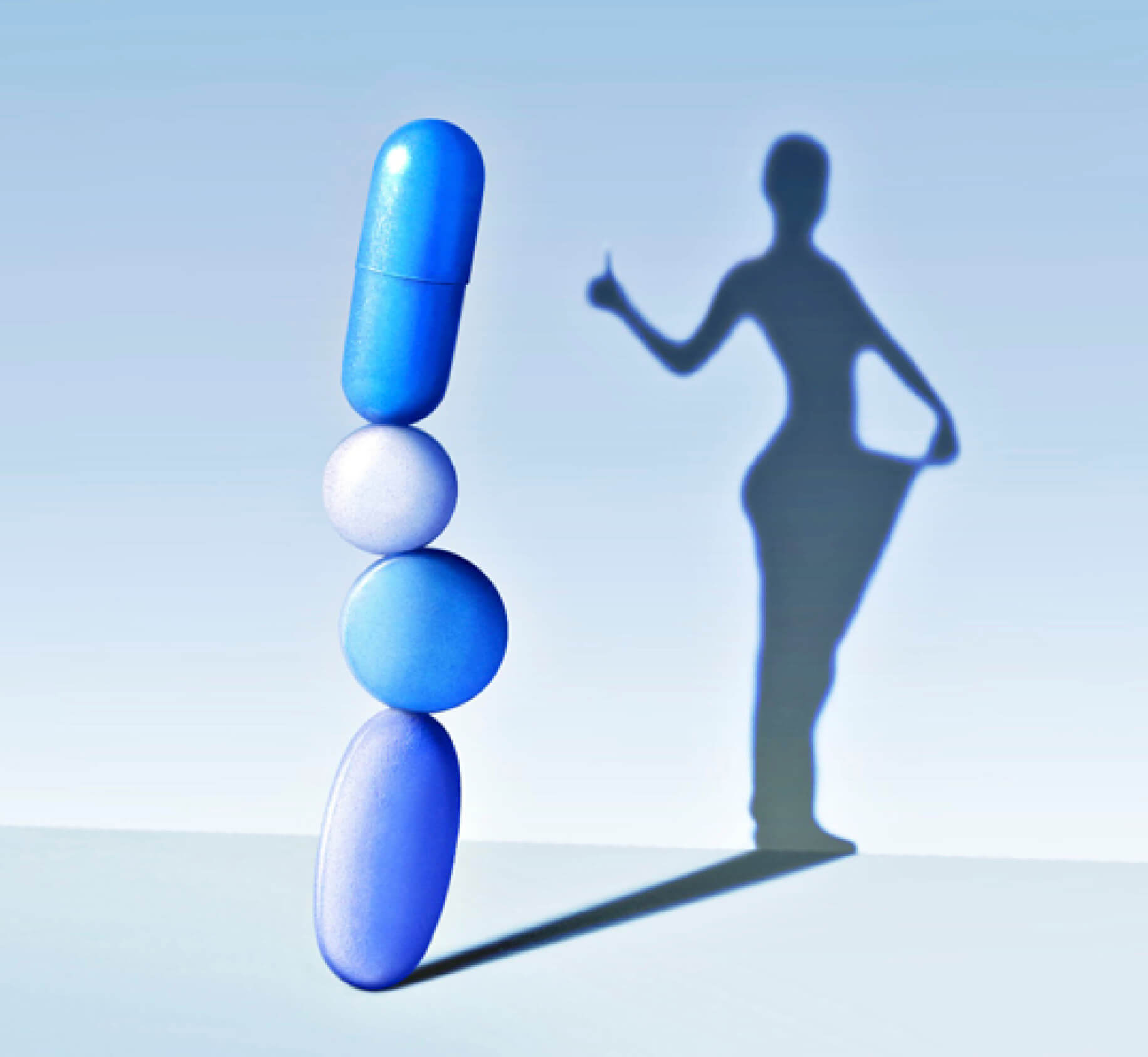 Conceptual illustration of a stack of 4 weight-loss pills casting a shadow of a figure pulling loose clothing away from its body