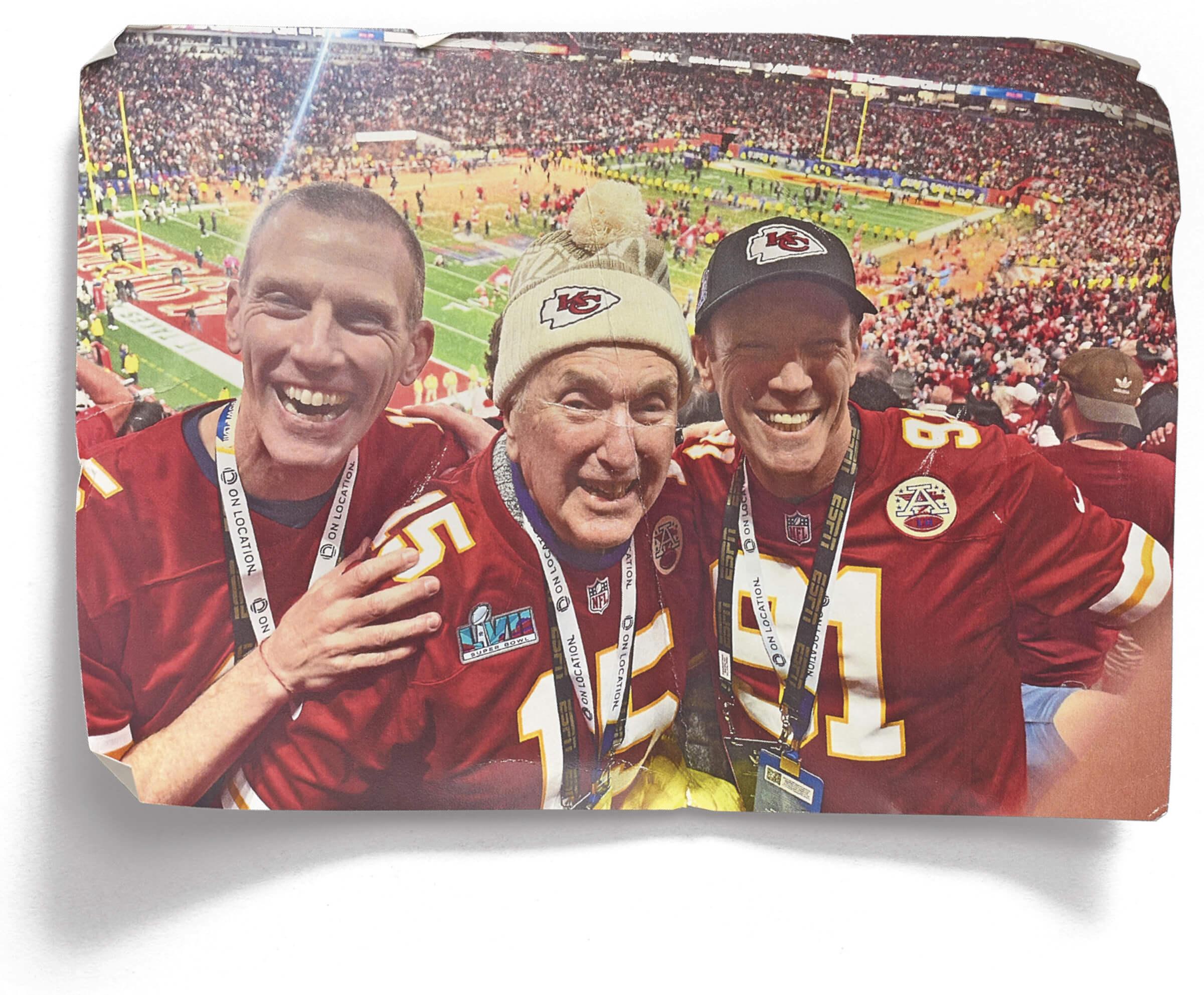 Photograph of Jamie, his brother Jordan along with their dad Kurt at a football game 