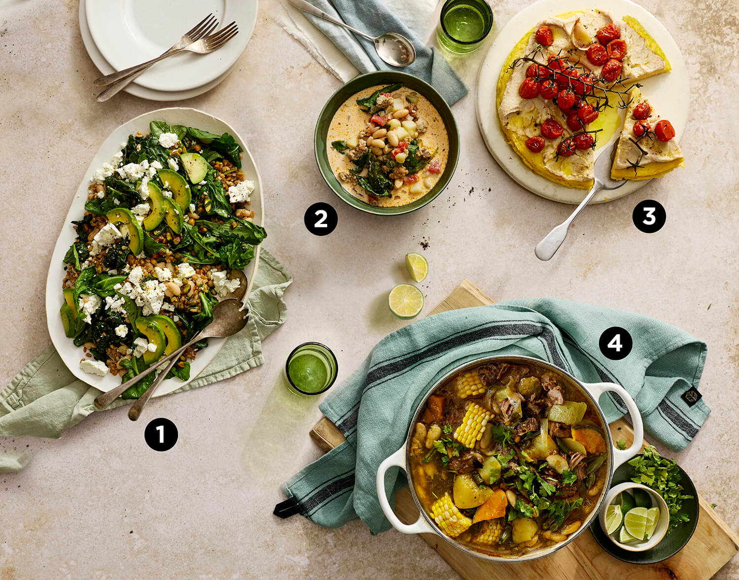 Top view photograph of a table with several decedent looking dishes with the main ingredient as white beans. 