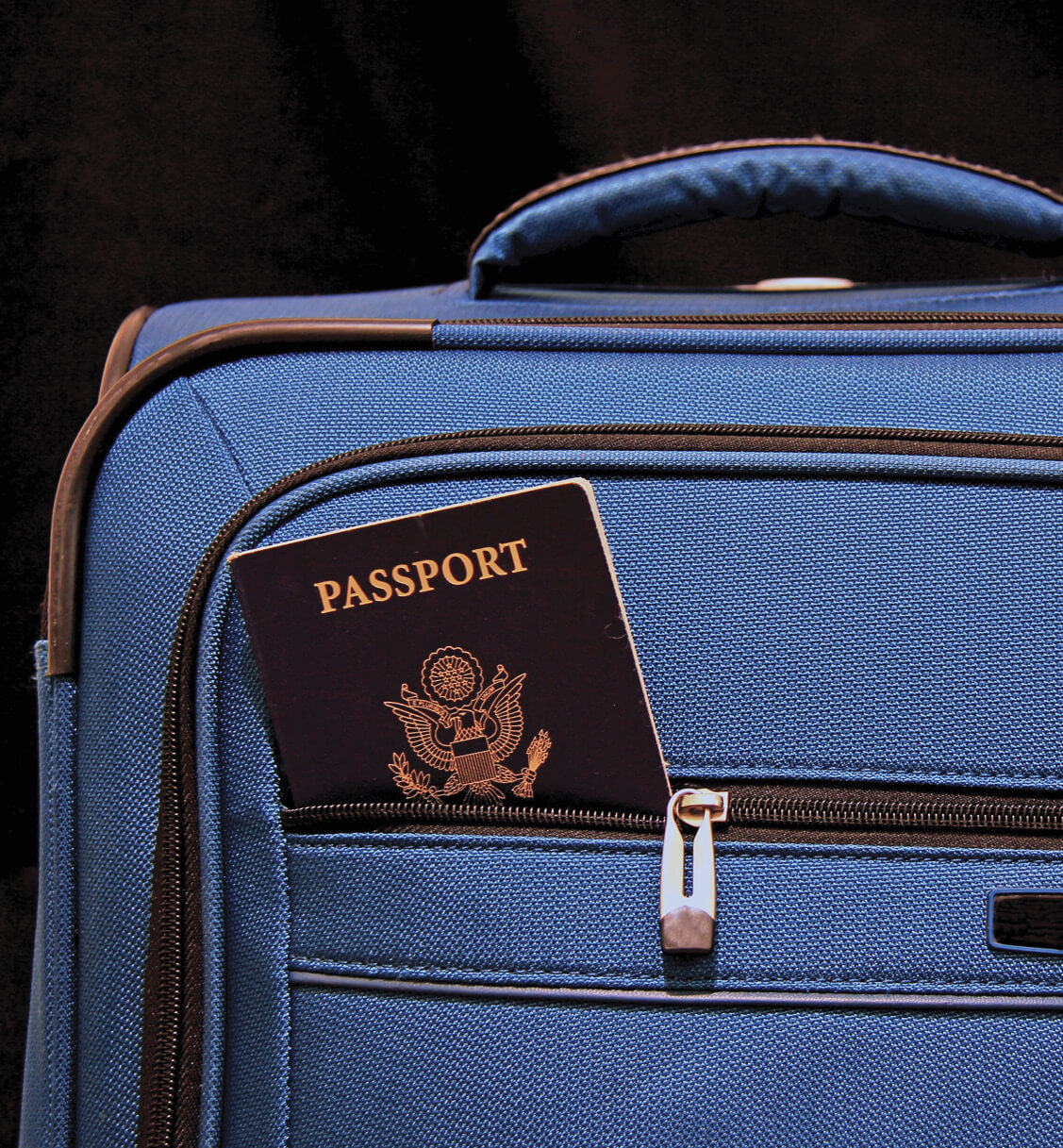 A suitcase with a passport sticking out 