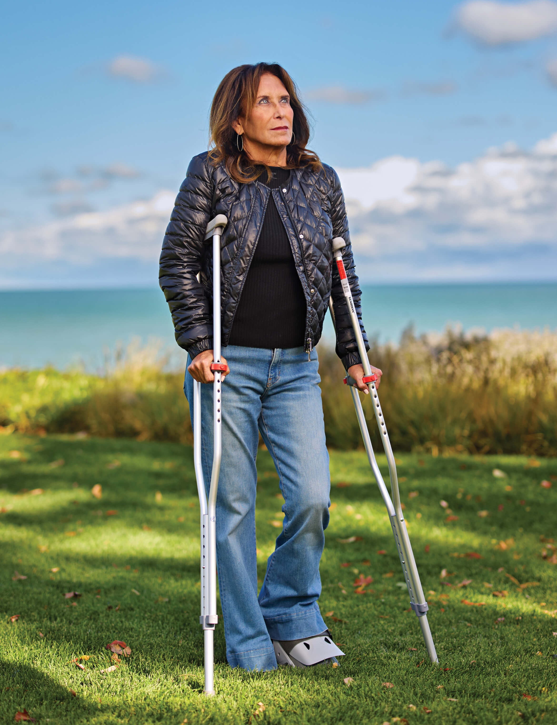 Photo portrait of Sheila Gutman standing with crutches