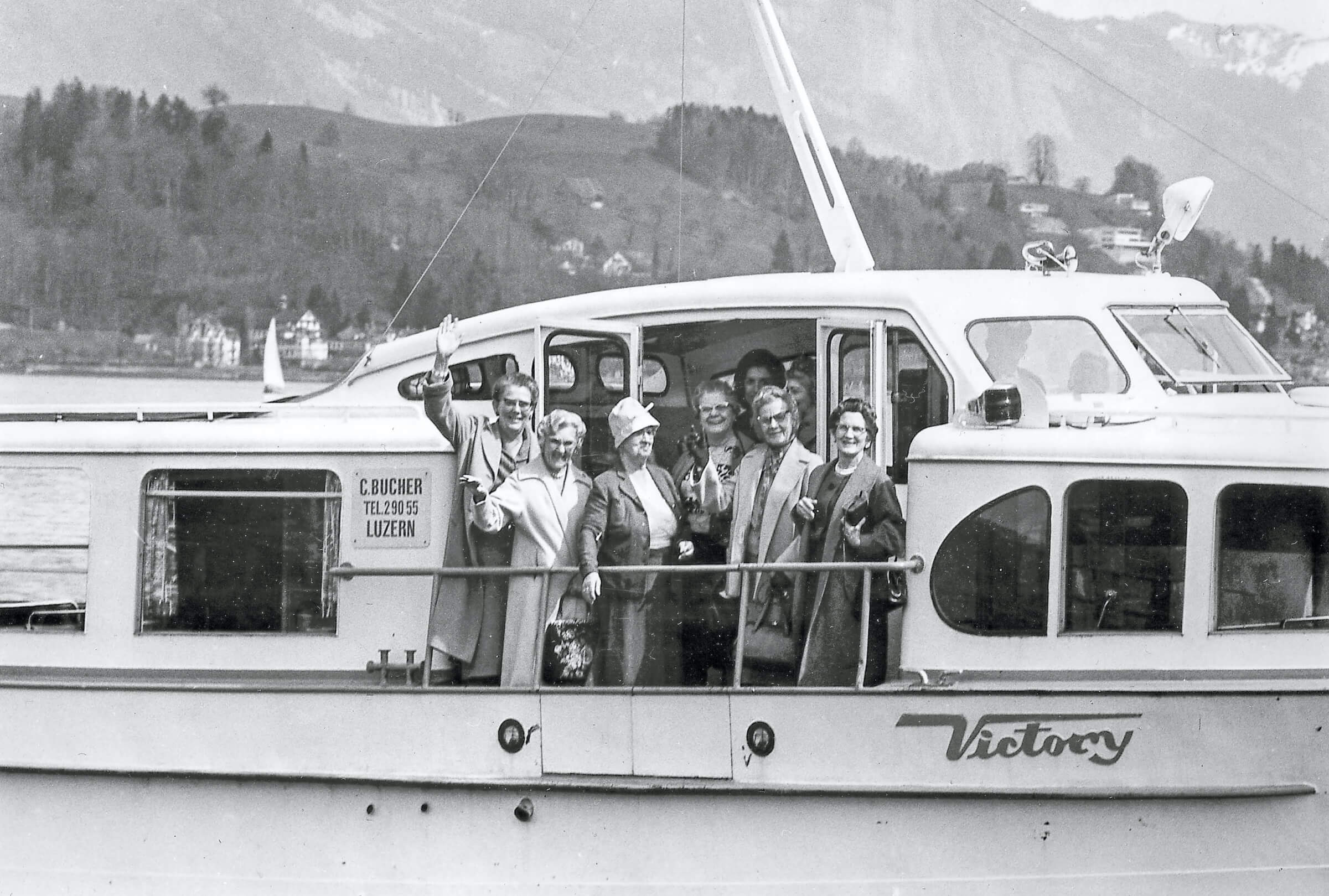 Vintage black and white photo of people on a group boat tour