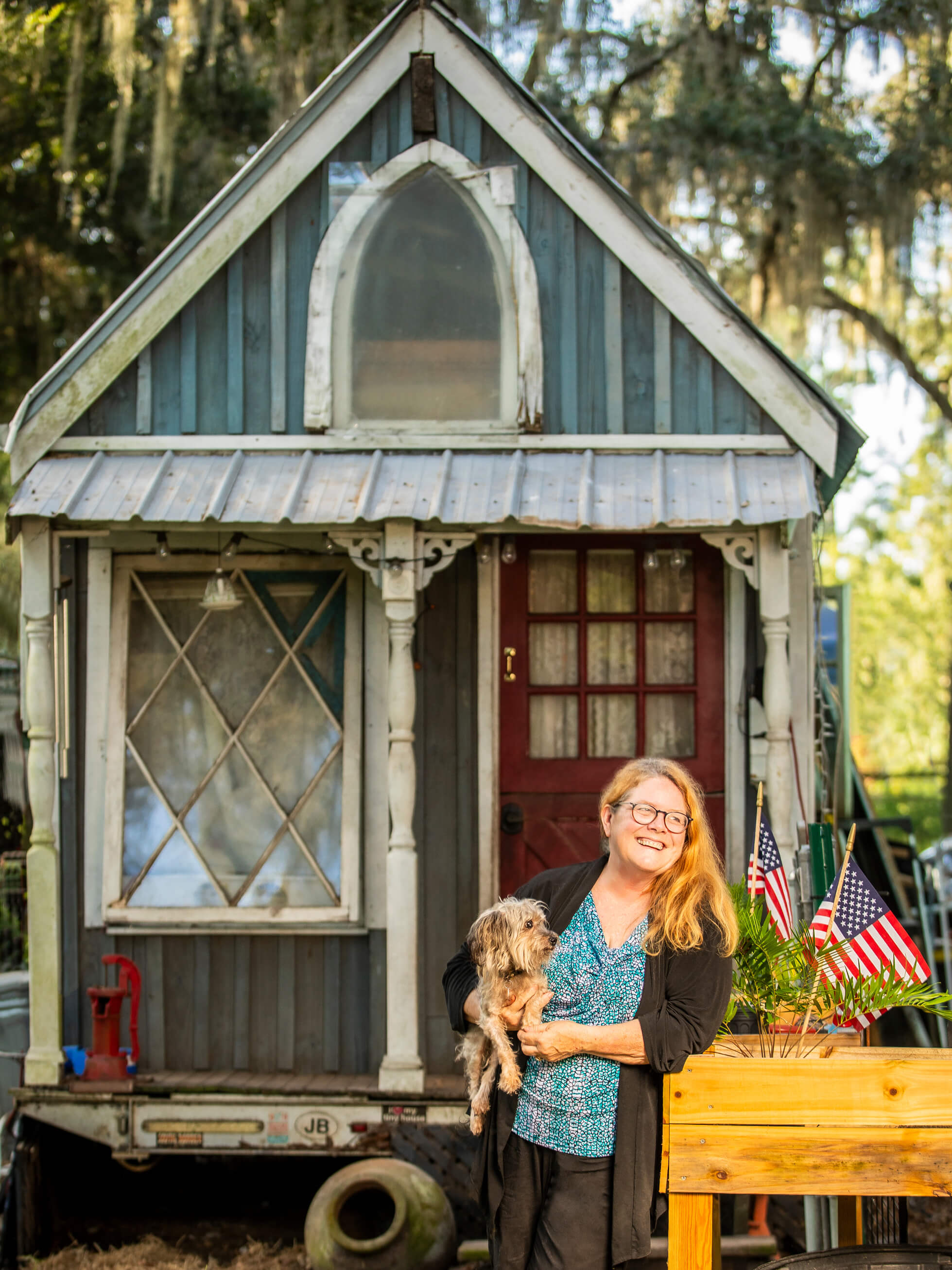 Photo of Shorty Robbins with her dog in front of her tiny house