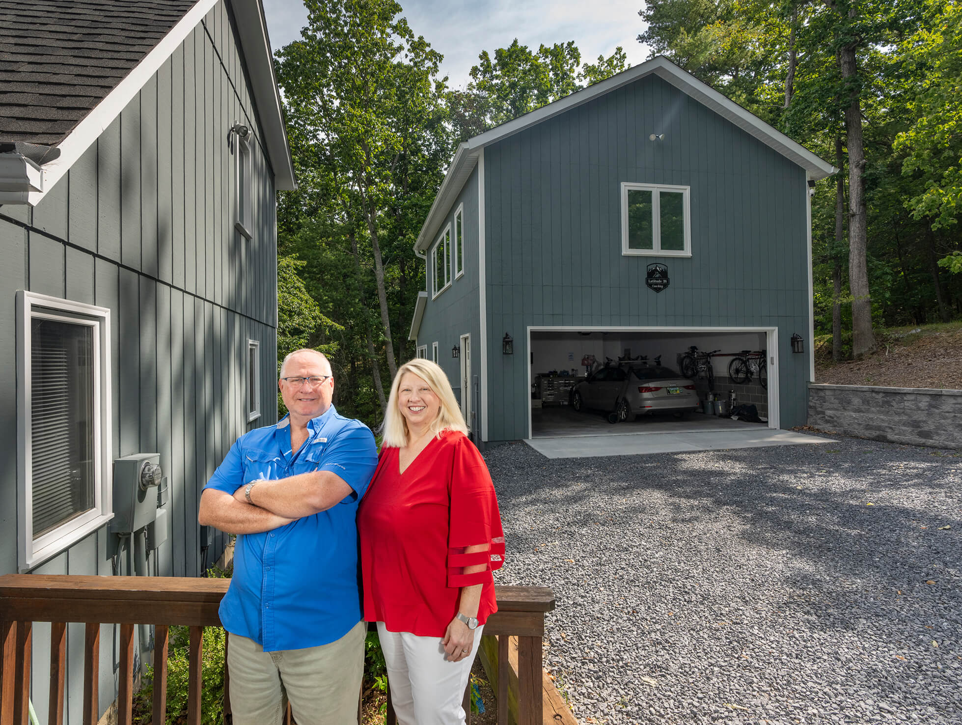 Photo of Jim and Ann Davison in front of their house with their new garage in the background