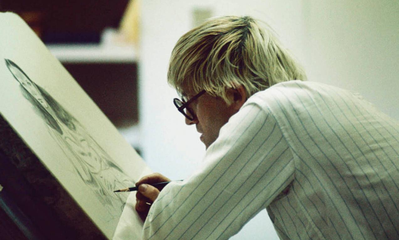 Photo of David Hockney at his easel in 1965