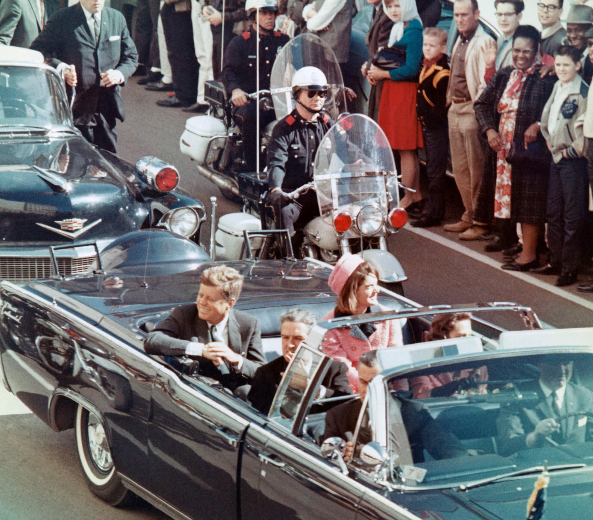 Vintage color photo of John and Jackie Kennedy riding in their limousine in Dallas before JFK was assassinated