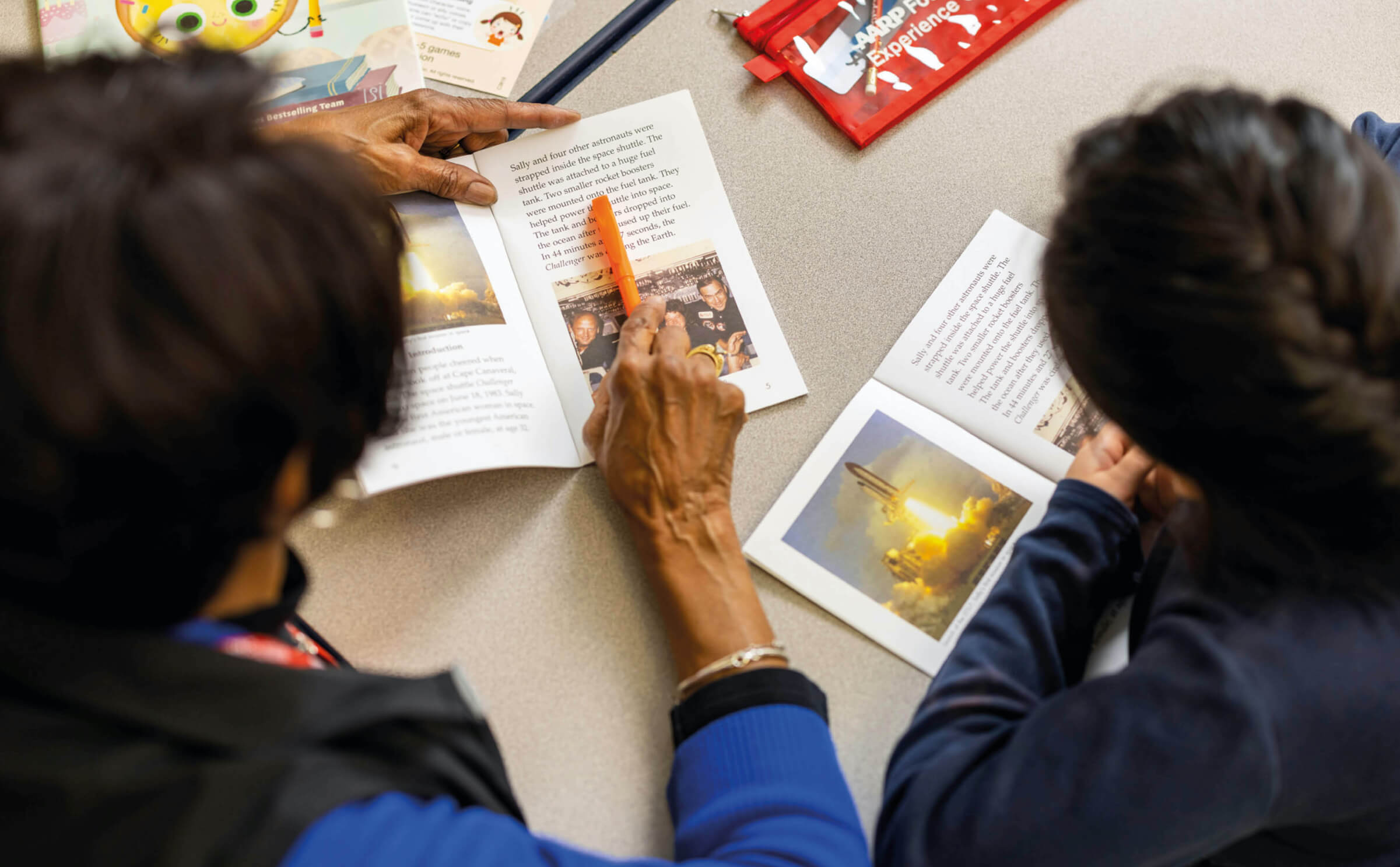 Photo of an AARP Experience Corps volunteer tutoring a young student