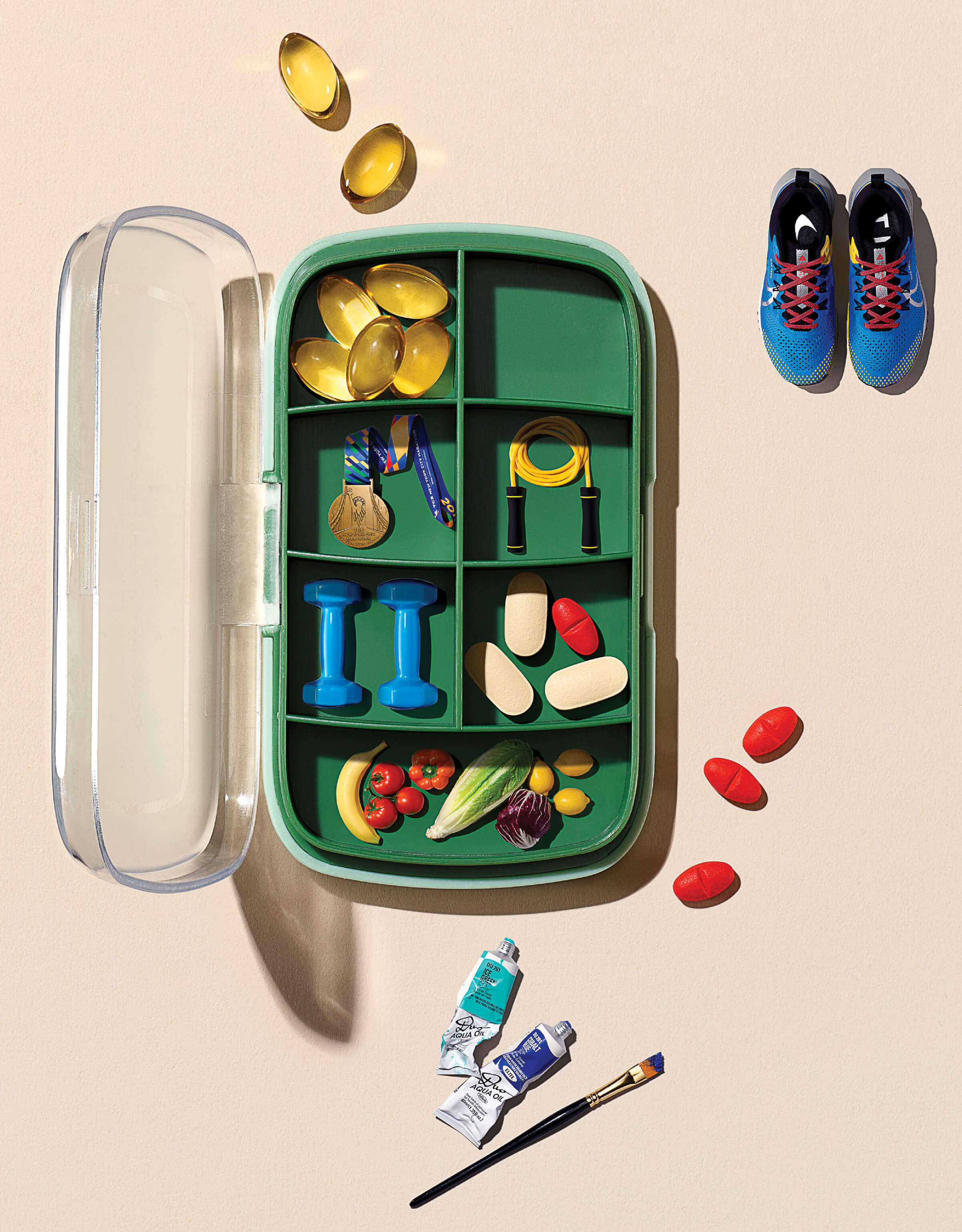 Conceptual photo of a pill box containing various elements of a healthy life