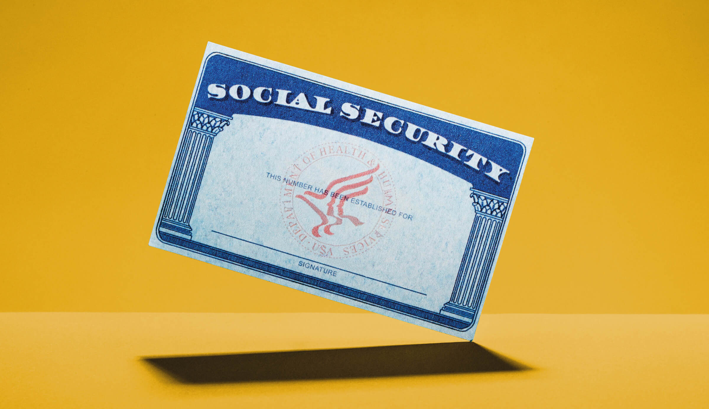 Photo of a social security card on a gold-colored background