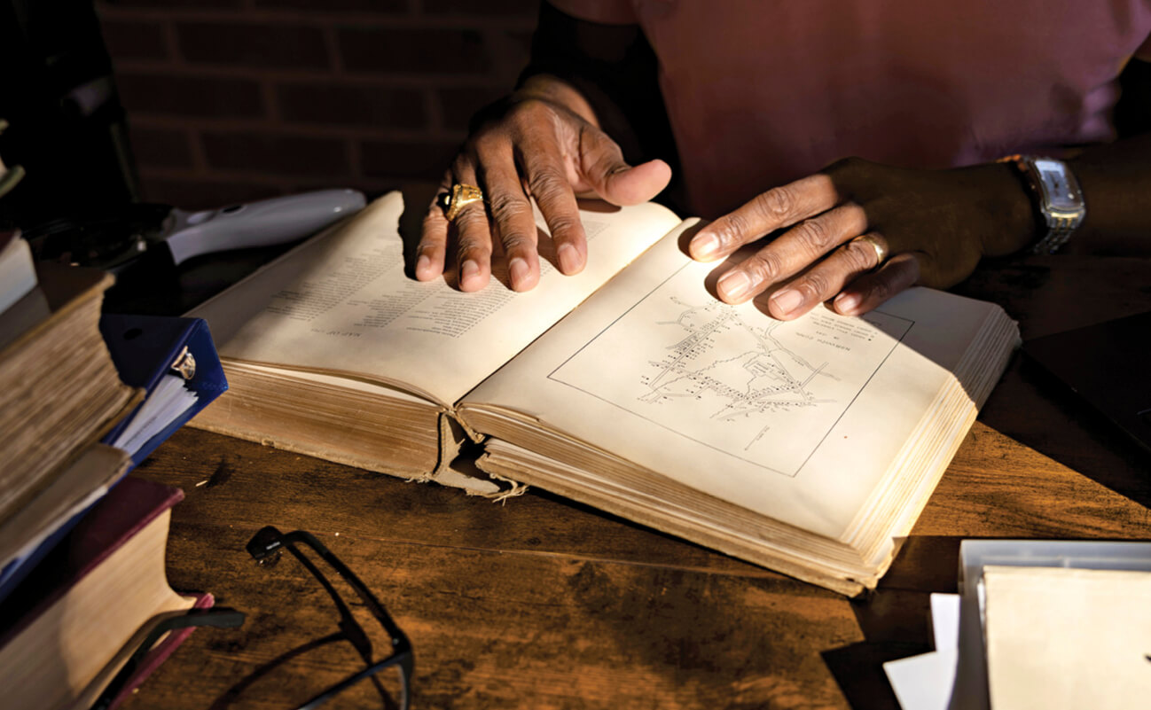 Photo of John researching in an old book