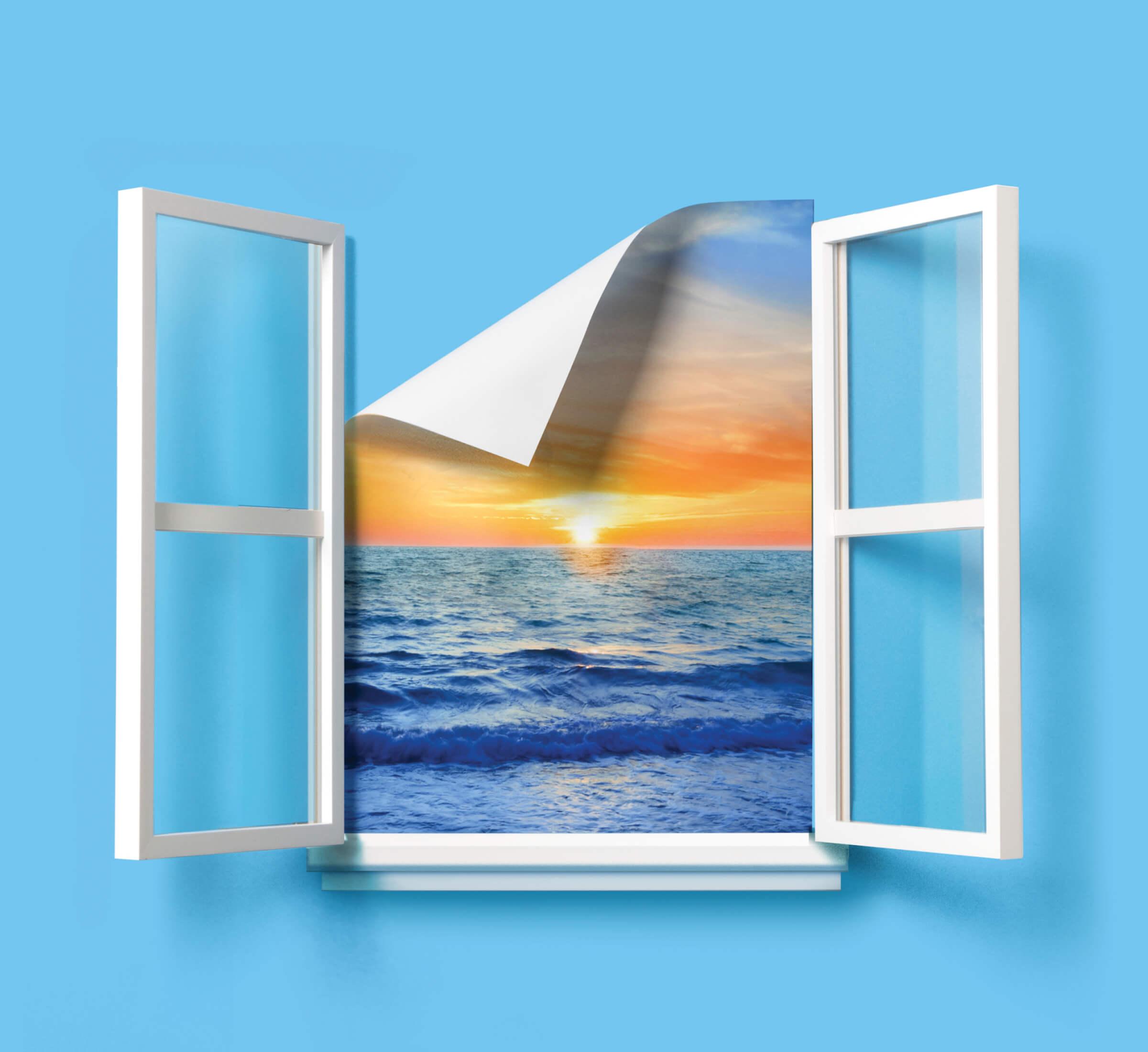 Photo illustration of an open window, the beach view is falling down