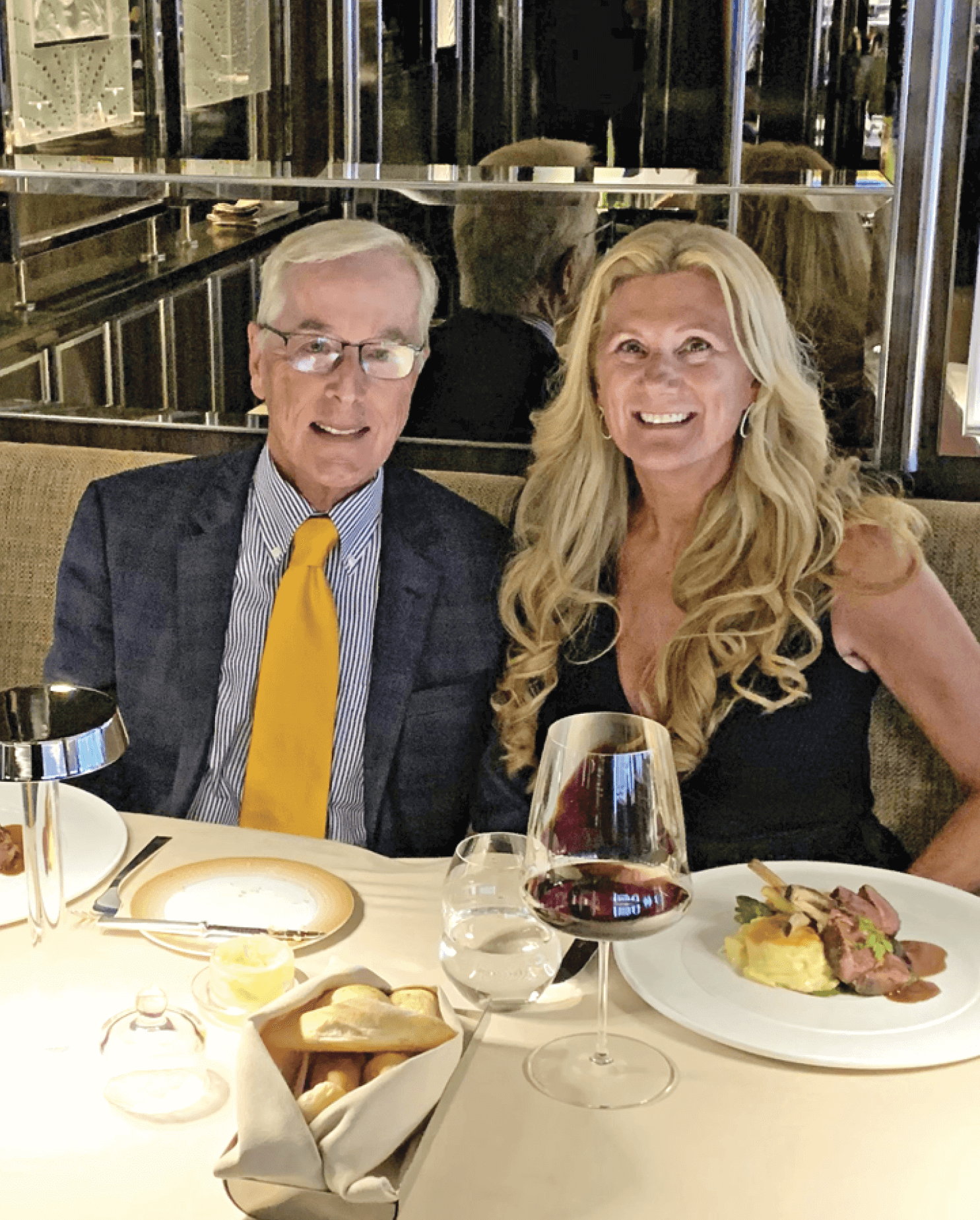 Photograph of Bob Dickinson sitting with his wife having dinner&nbsp;