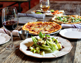 Photo of pizza and salad on table