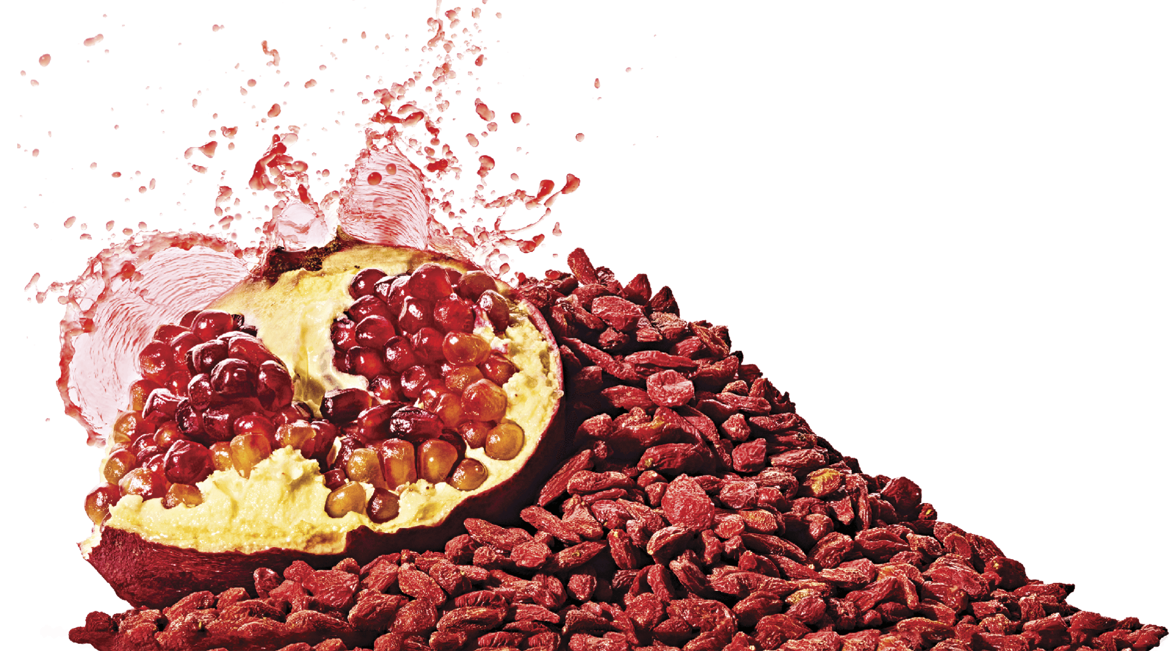 Photo of an open pomegranate next to a pile of goji berries