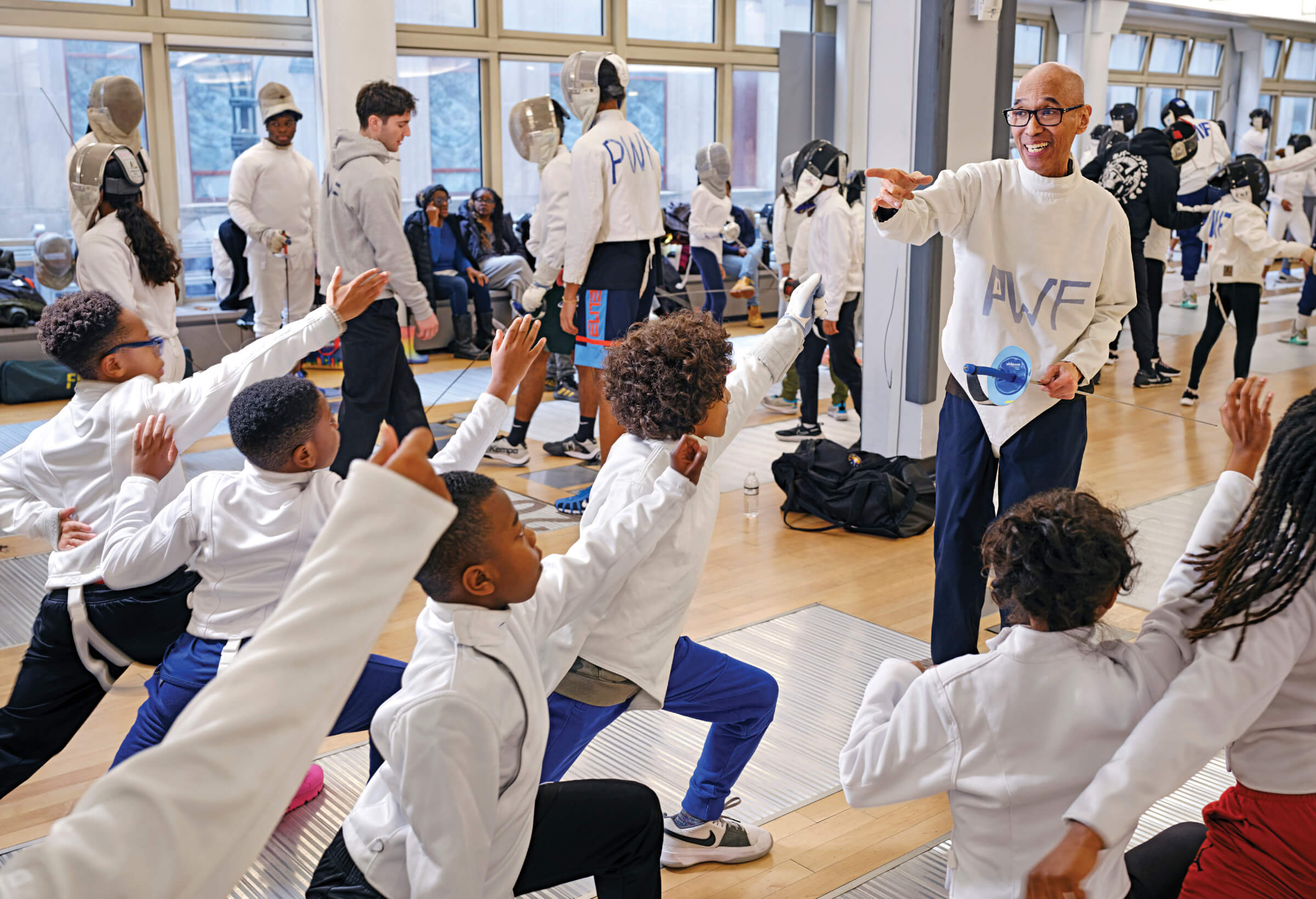 Photo of Peter Westbrook teaching a group of young fencing students