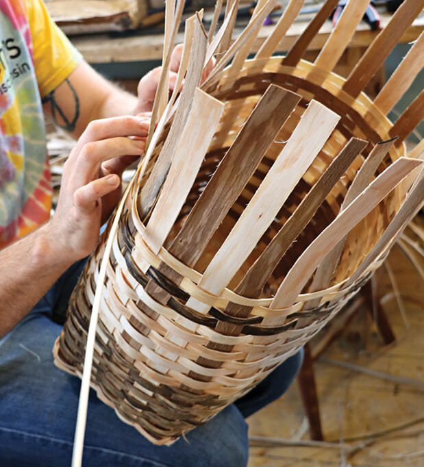 Photo of hands weaving a basket