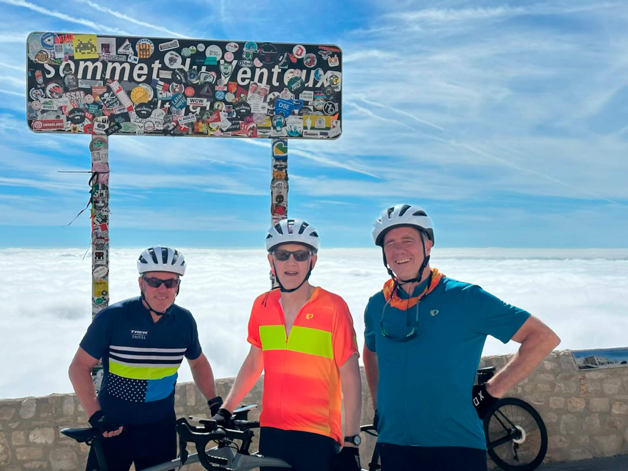 Photo of three male cyclists at top of Mont Ventoux