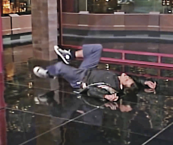 A man lying on the ground in pain 