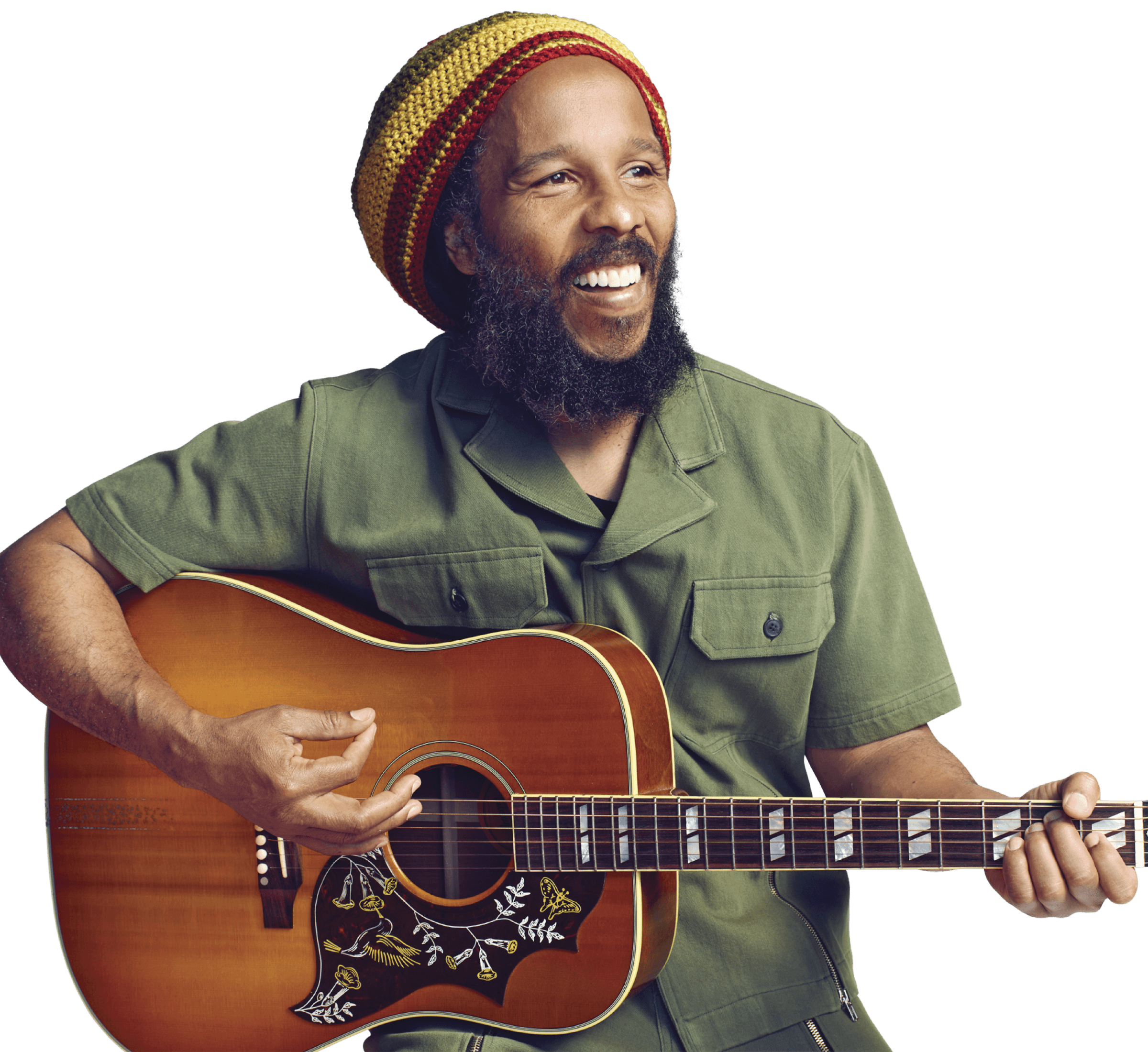 Photograph of Ziggy Marley playing the acoustic guitar. He is wearing a beanie and a bottle green button-down shirt. 