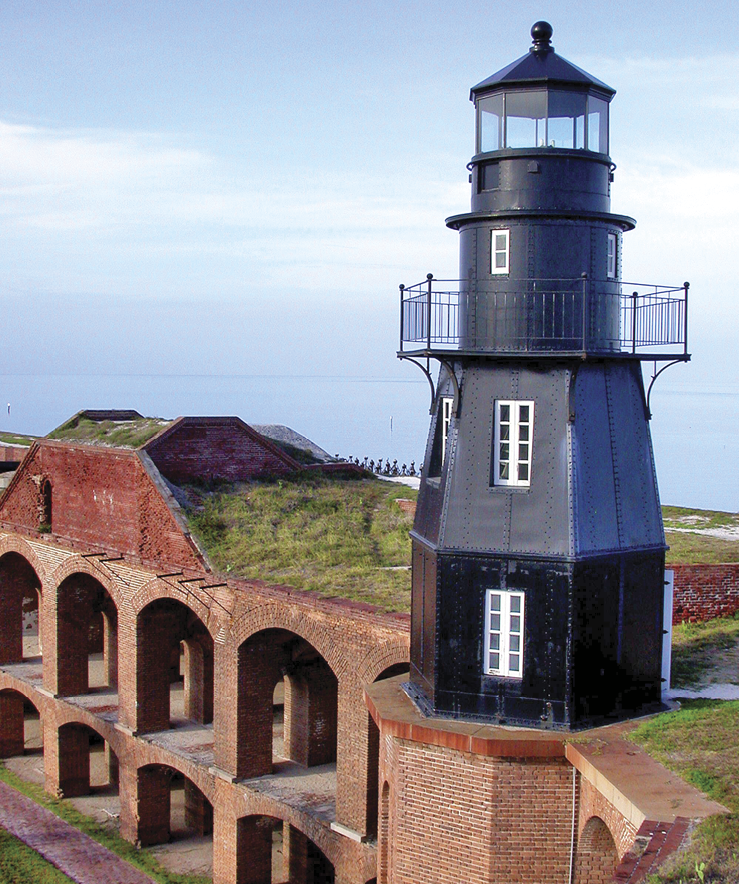 Image of the secluded fort in Florida. It is made of bricks and a black lighthouse sits in the middle 
