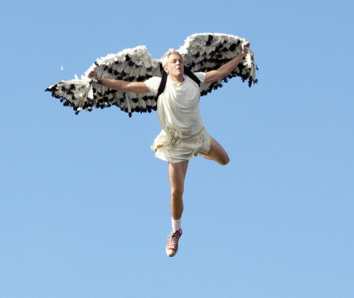 A man flying with makeshift wings 