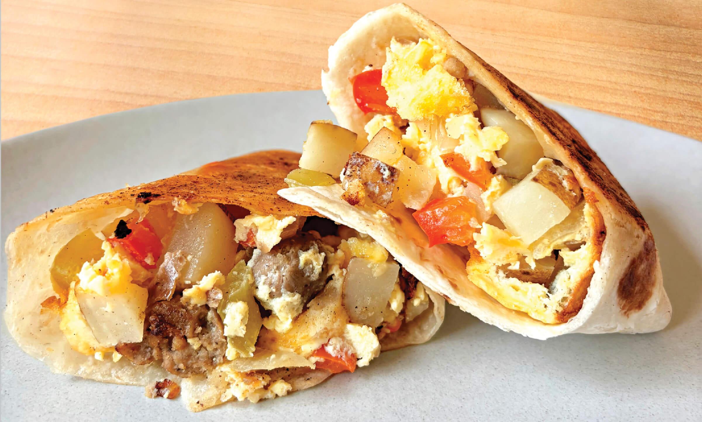 Image of a burrito cut in half on a plate 