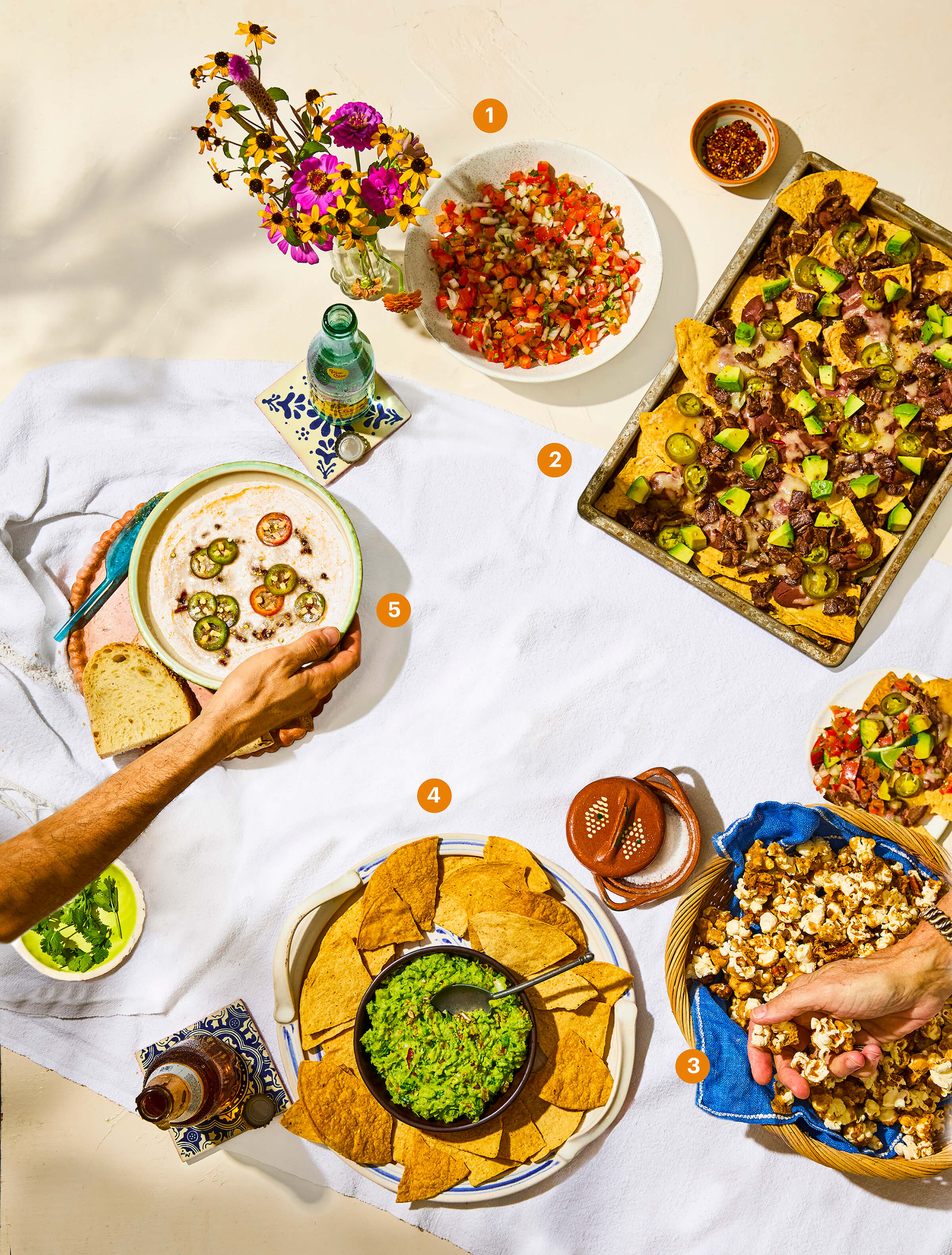 Top view of a table spread with various different snacks 
