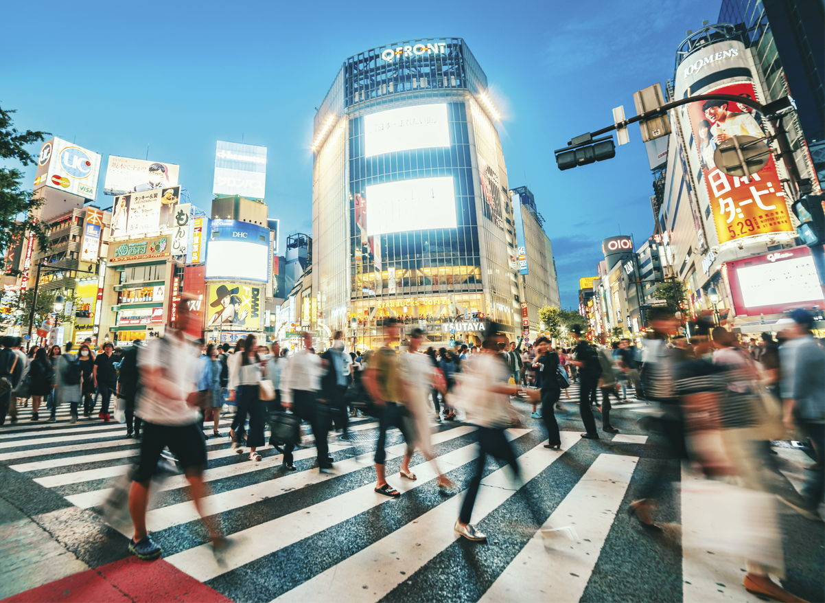 Photograph of a busy street in Tokyo at night 