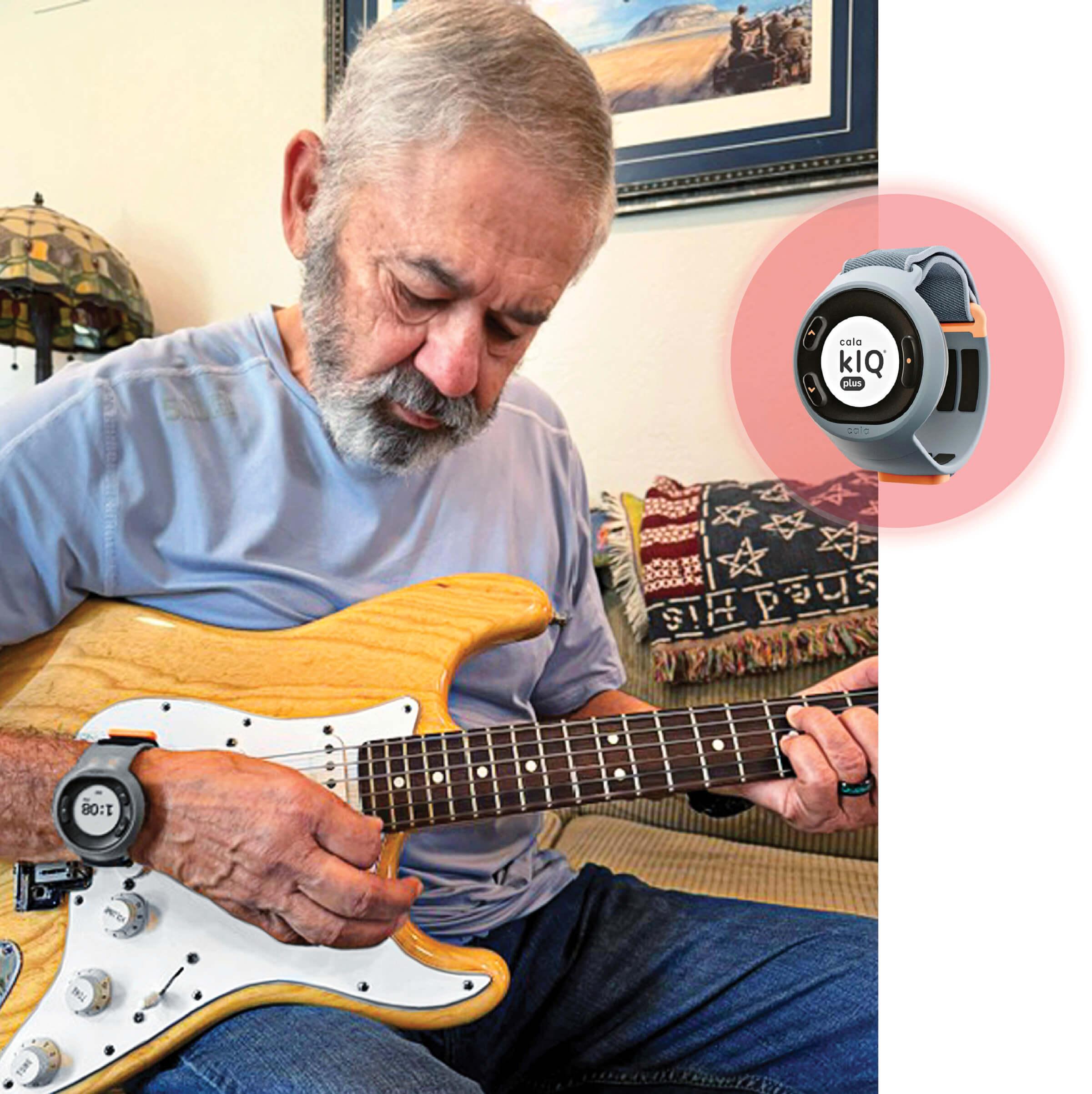 Image of Payne playing an electric guitar and wearing a wristband 