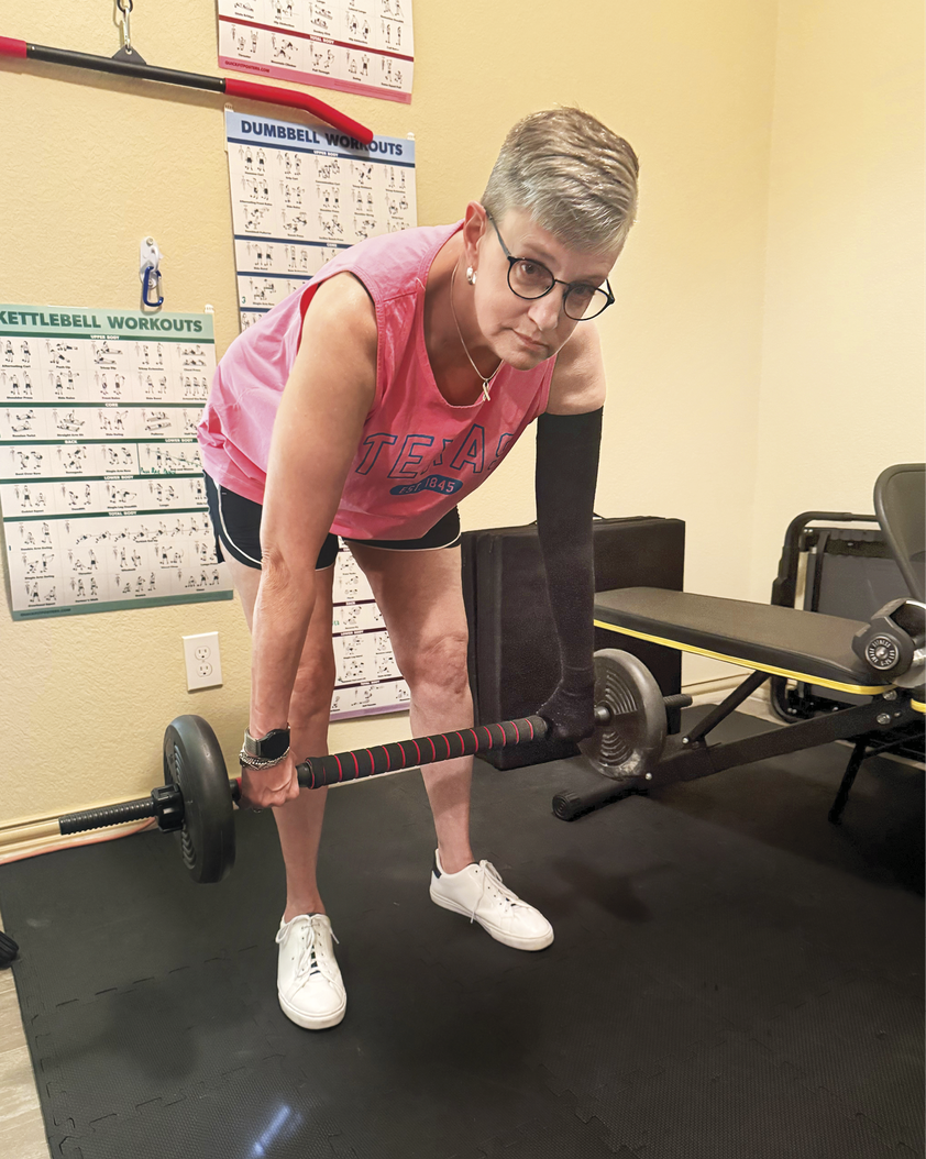 Photograph of Bashein lifting weights in the gym