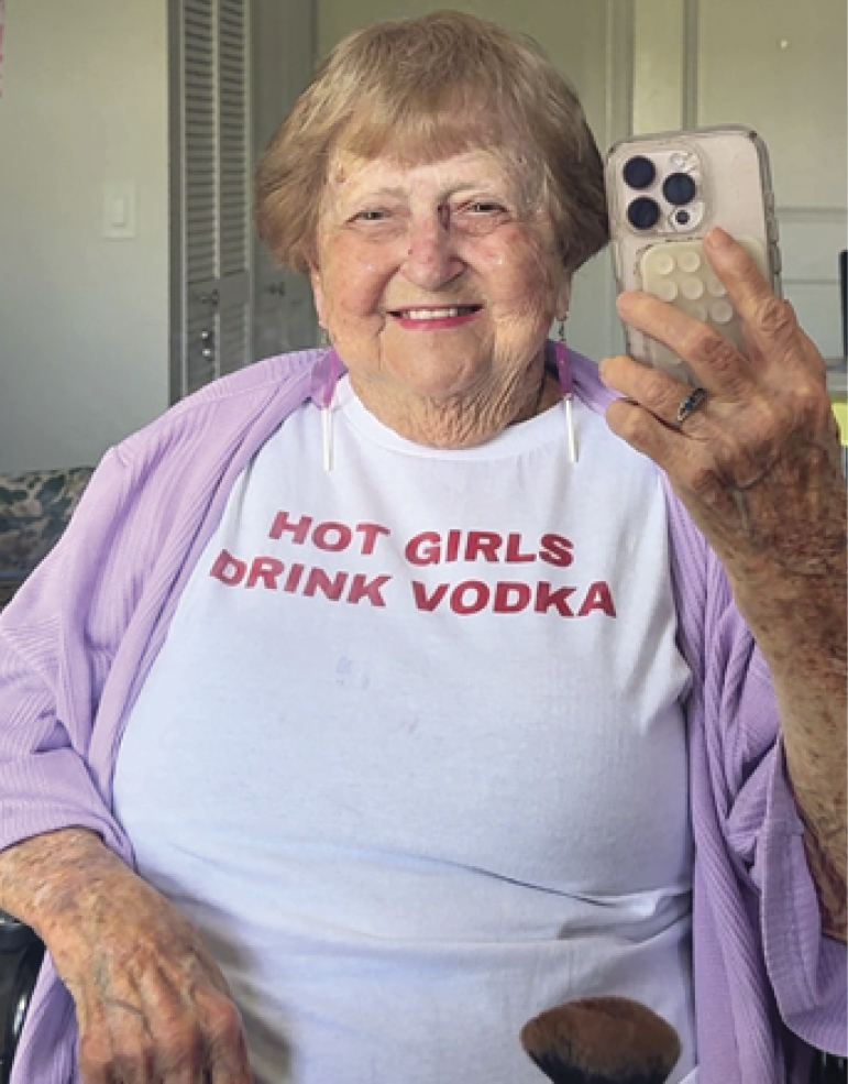 Photograph of Grandma Droniak wearing a t-shirt that says Hot girls drink vodka
