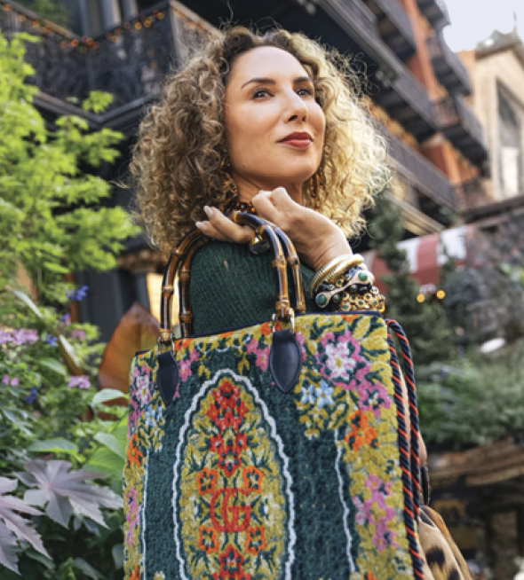 Photograph of Carla Rockmore carrying a colorful fabric bag