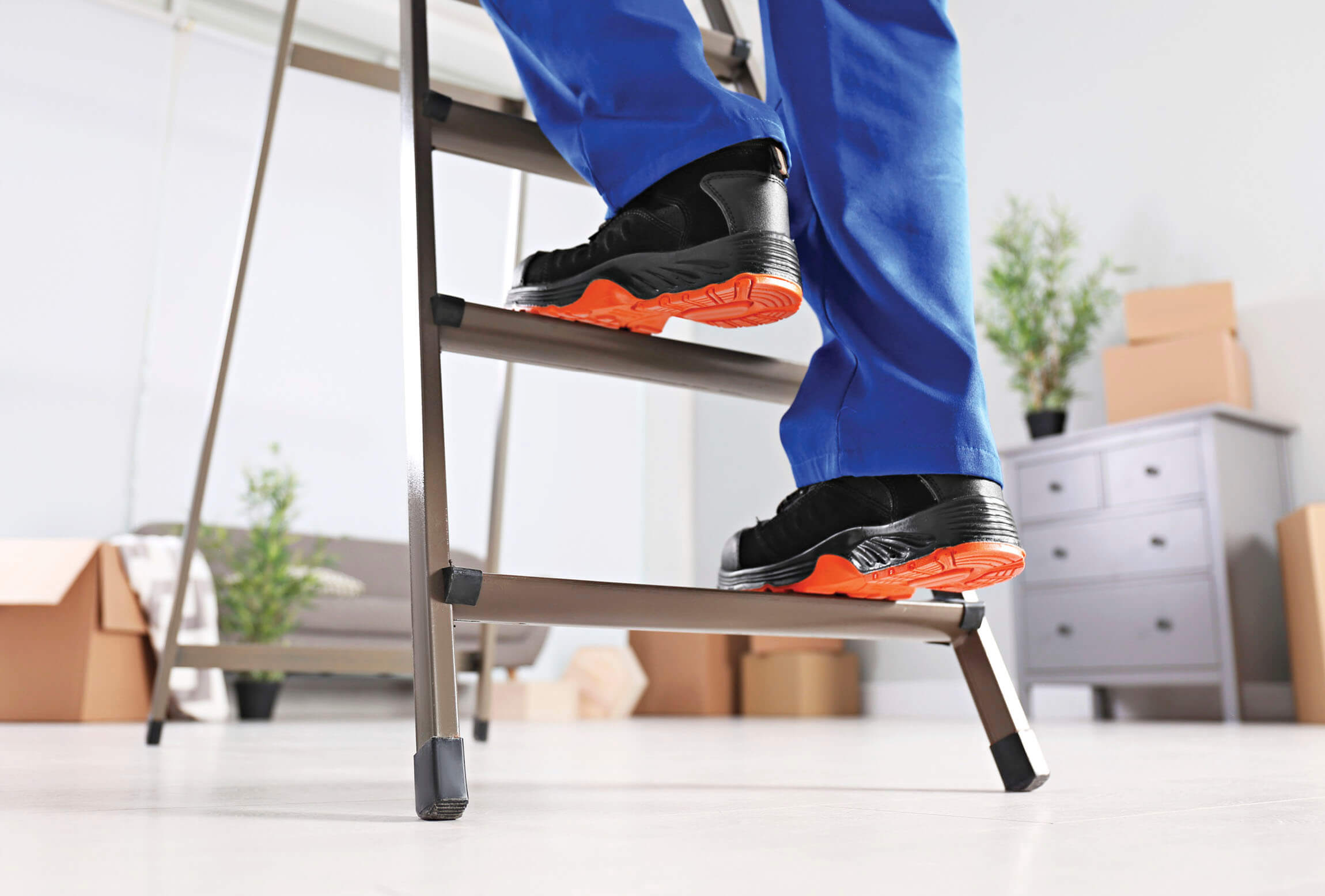 Photograph of a person walking up the ladder 