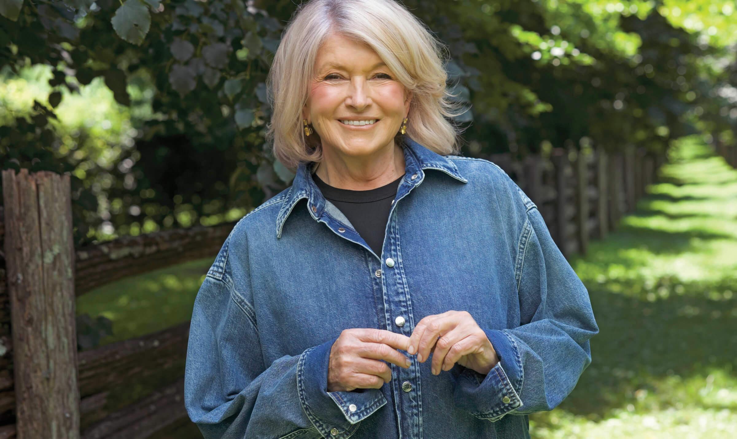 Portrait of Martha Stewart wearing a denim shirt and smiling at the camera 