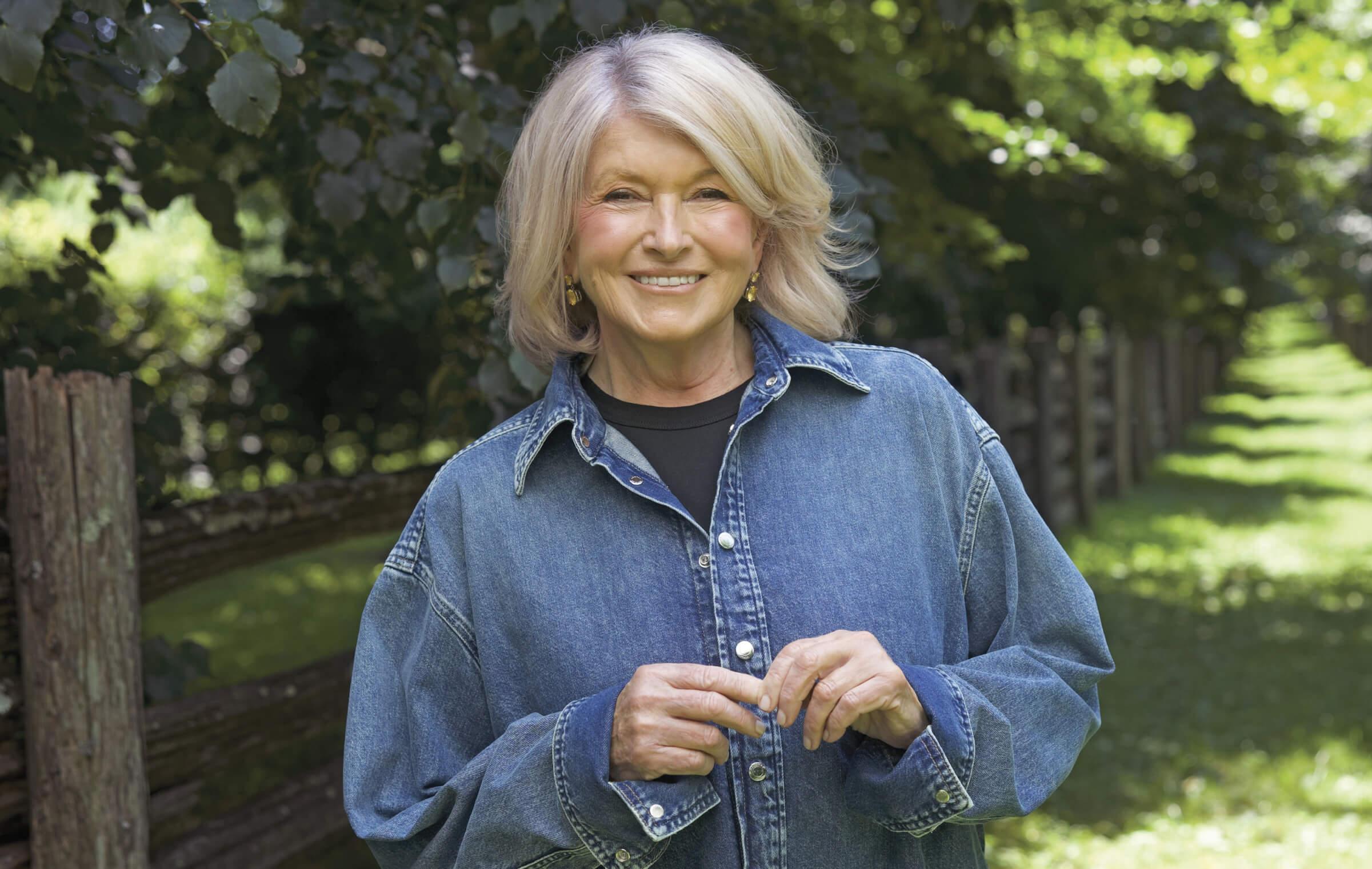 Portrait of Martha Stewart wearing a denim shirt and smiling at the camera