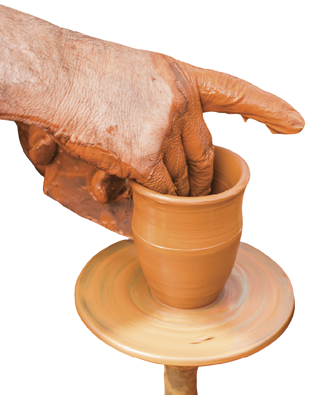 Zoomed in picture of a person throwing a mug on a wheel 