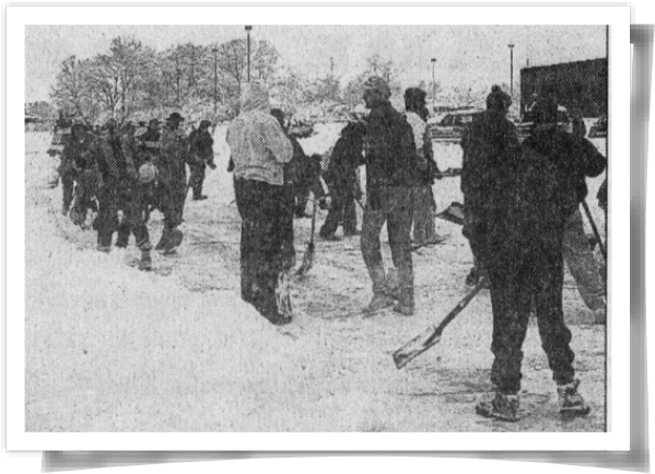 Black-and-white photo of people clearing a snow-covered parking lot so a helicopter could land to take a 3-year-old girl to the hospital for a liver transplant