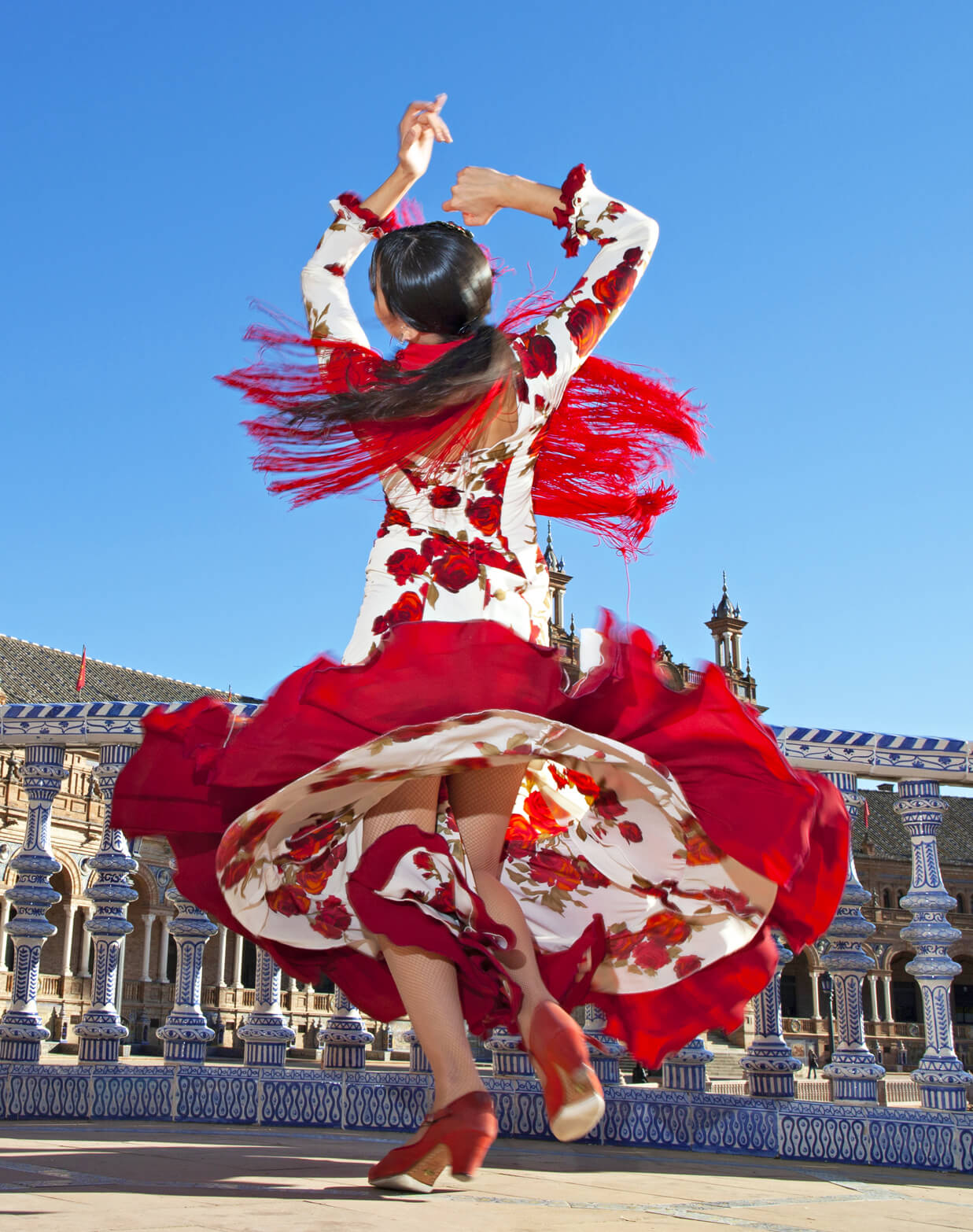 Photo of a traditionally-dressed woman dancing the flamenco