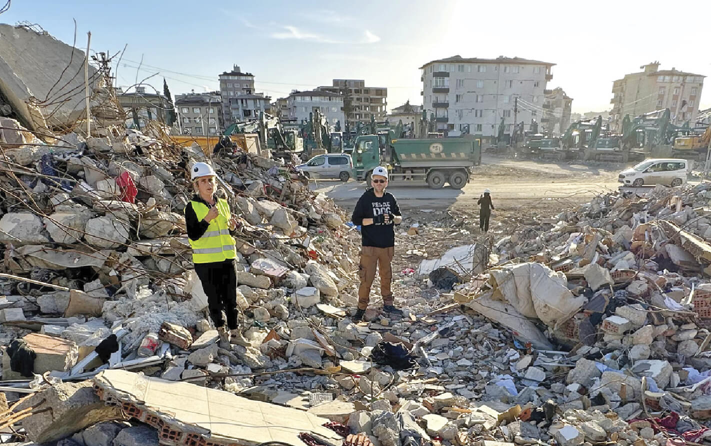 Photo of Michael Merrill hunting for pets amongst the rubble in Turkey