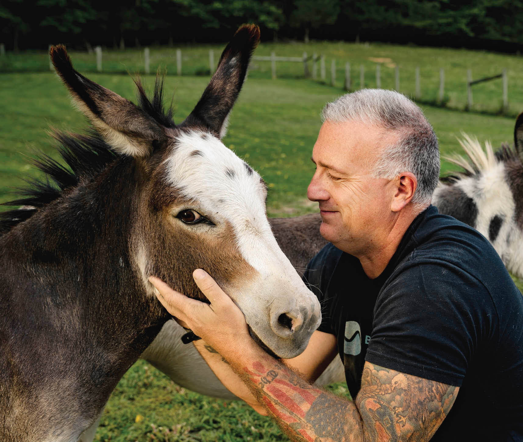 Photo of Heath Haug petting a donkey