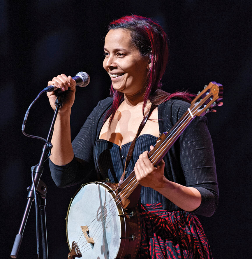 Photo of Rhiannon Giddens on stage holding a banjo