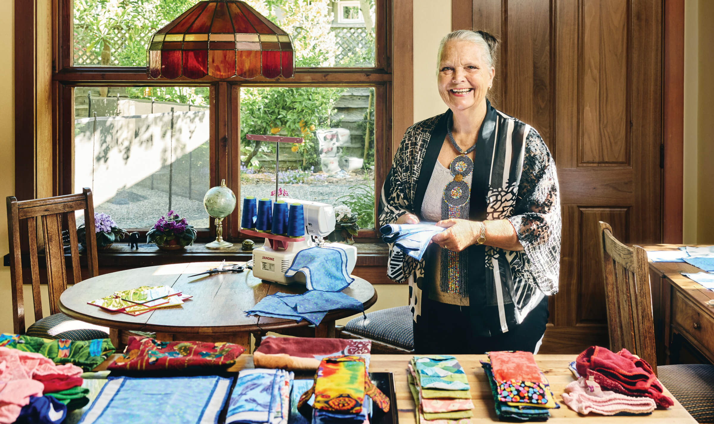 Photo of Brenda Birrell with period kits on her kitchen table