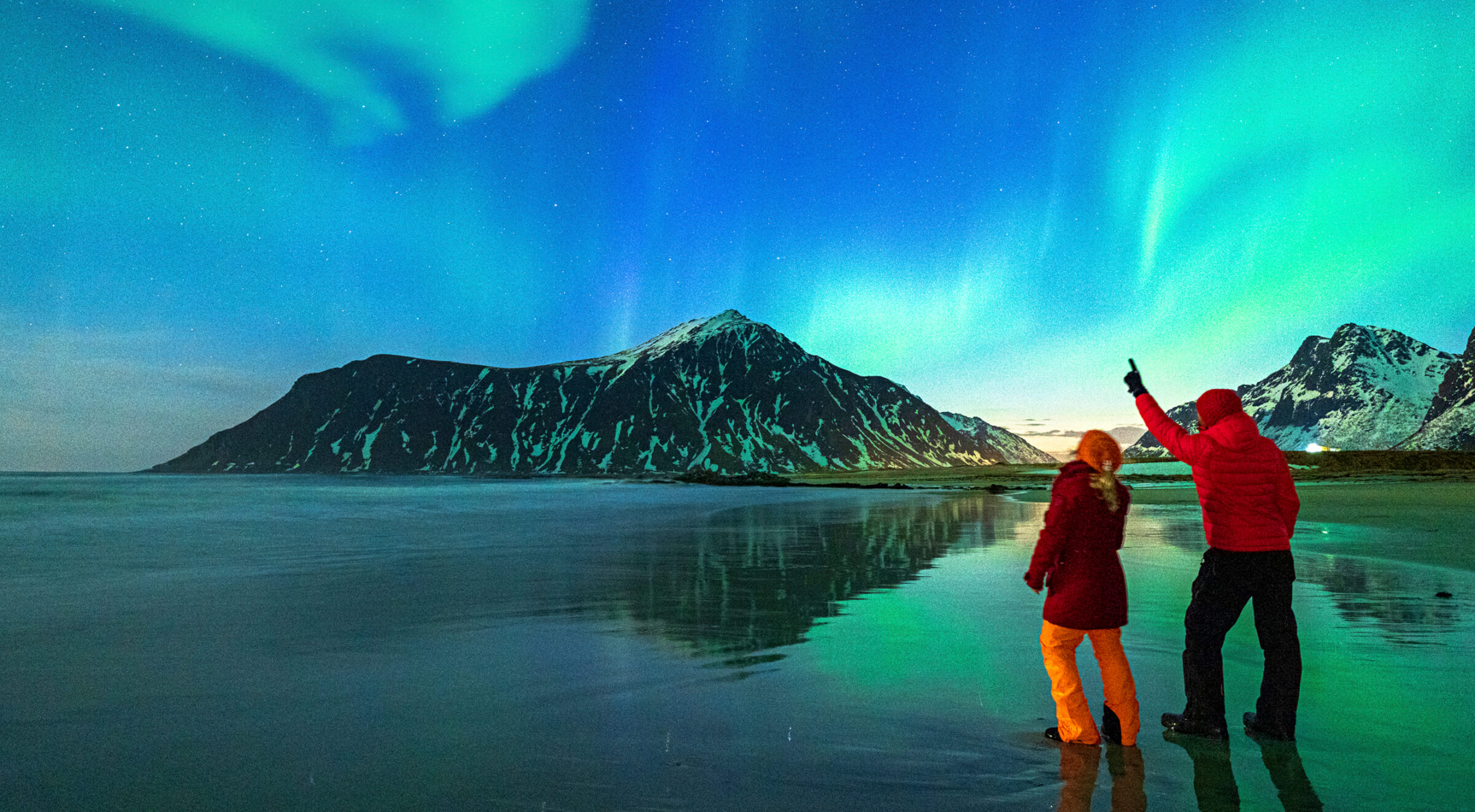 Photo of couple looking at the Northern Lights