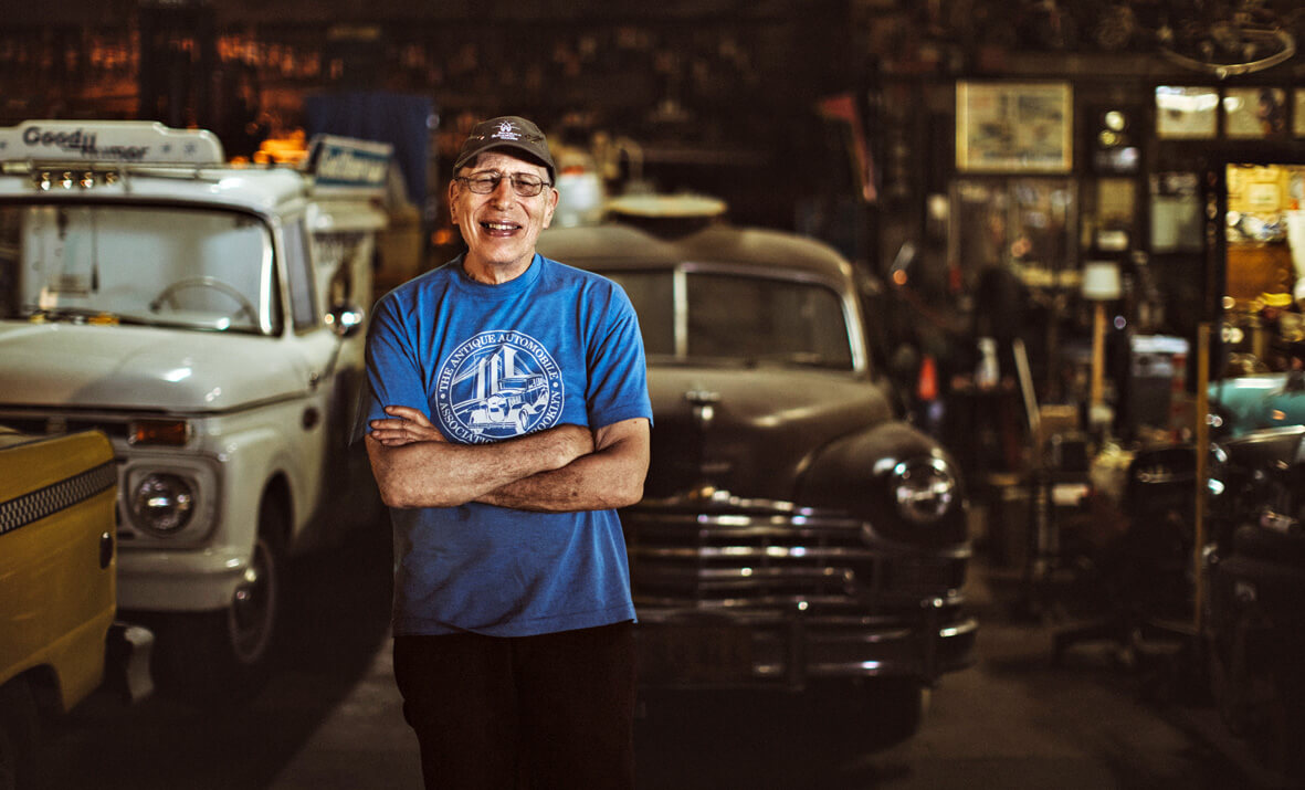 Photo of Lenny Shiller with a few of his 63 prized cars