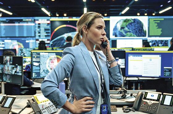 Still of Rebecca Ferguson in a blue suit talking on the phone from A House of Dynamite
