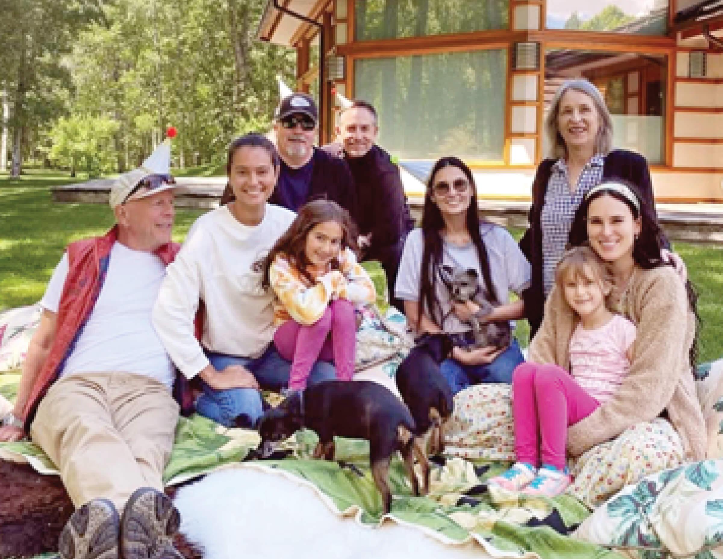A photograph of Willis clan (including Bruce’s ex-wife, actor Demi Moore) celebrating Emma’s 42nd birthday out in the yard