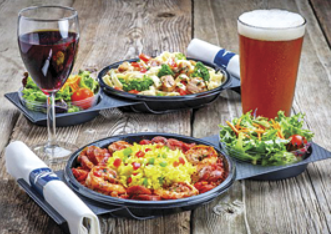 Photograph of 2 plates of food,a glass of wine and beer