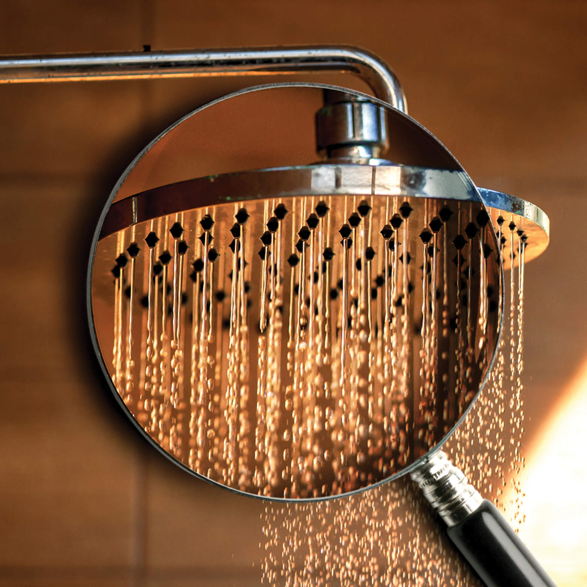 Photo illustration of a magnifying glass over a shower head