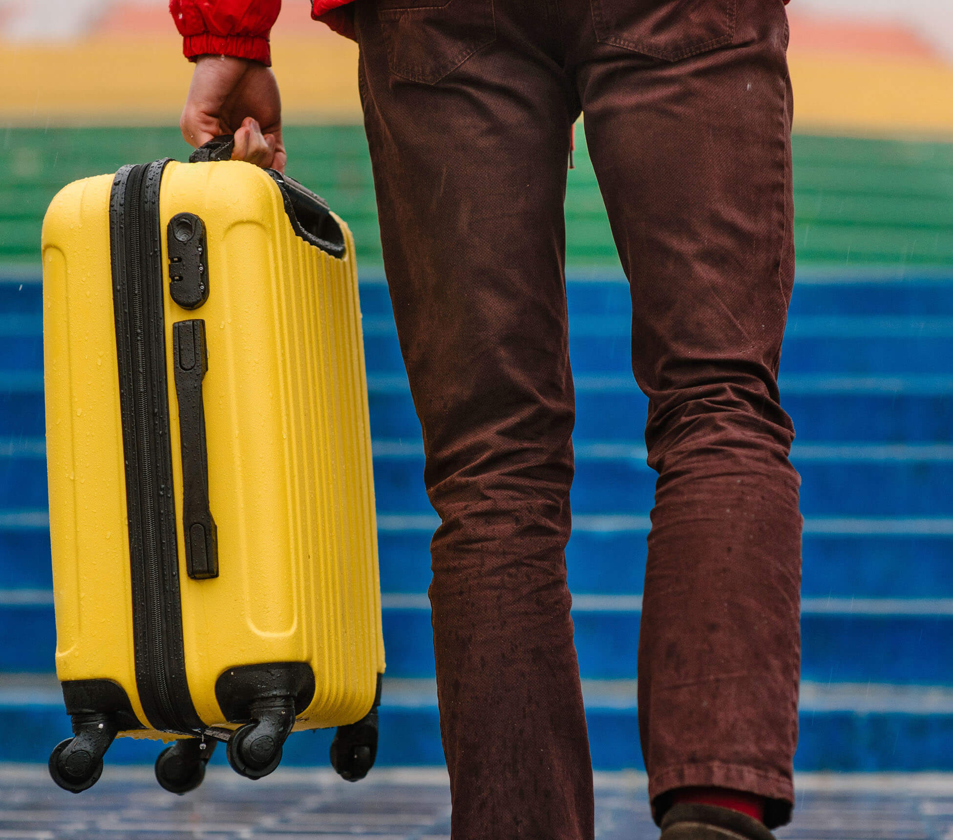 Photo of a man holding a carry-on bag