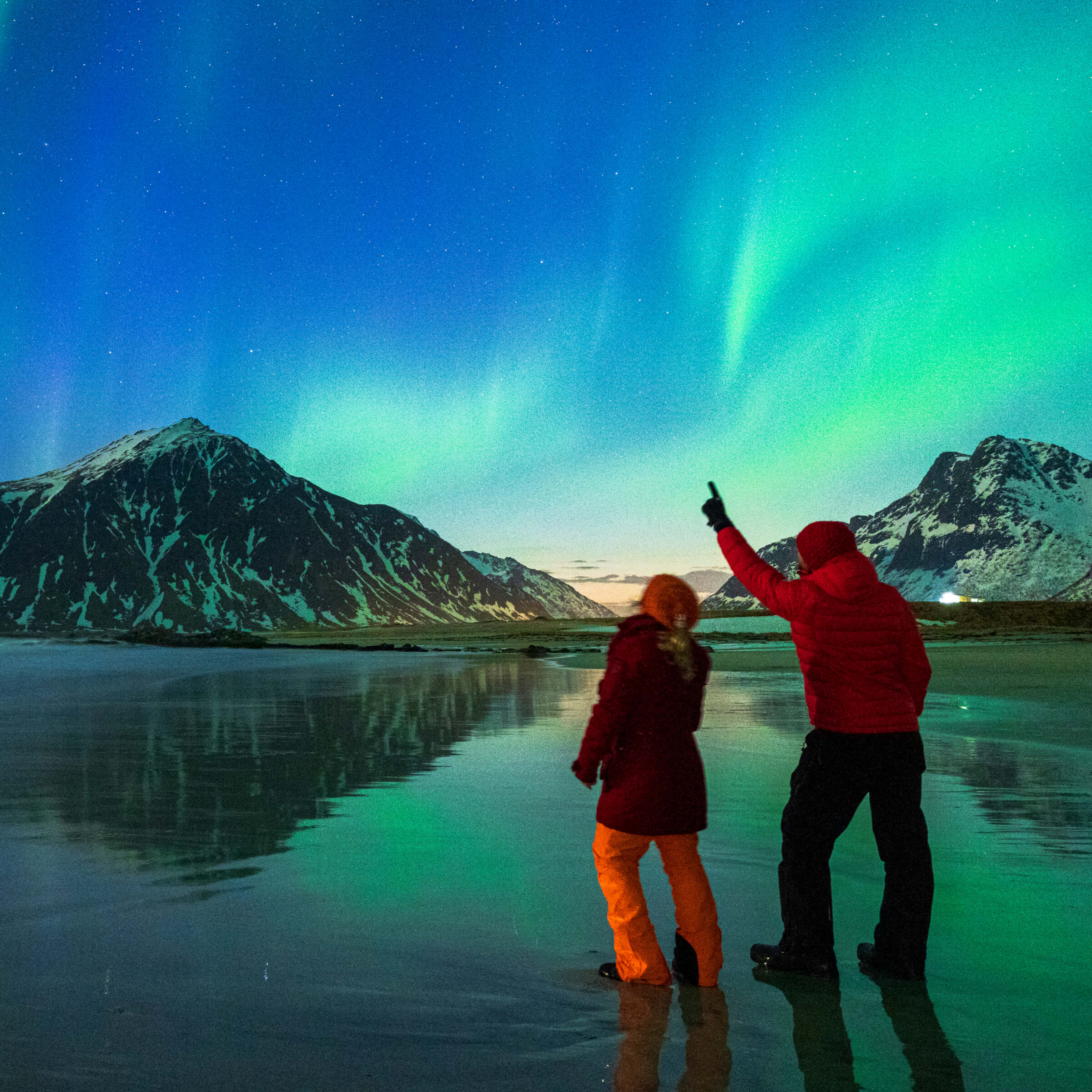 Photo of couple looking at the northern lights